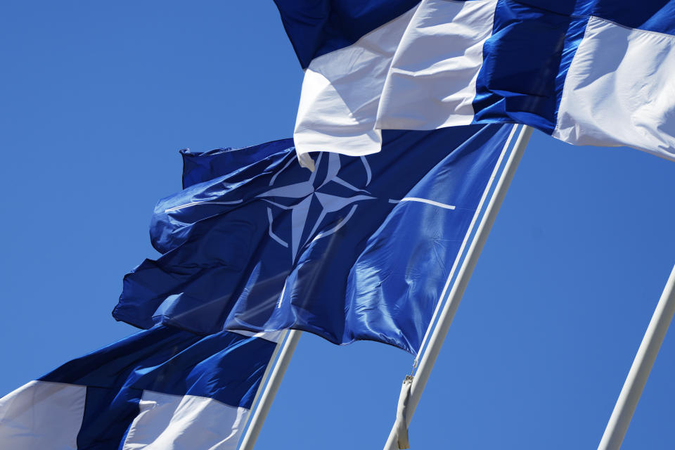 NATO and Finland flags flutter over the building of Ministry of Foreign Affairs in Helsinki, Finland, Tuesday, April 4, 2023. Finland prepared to make its historic entry into NATO Tuesday, a step that doubles the Western alliance’s border with Russia and ends decades of non-alignment for the Nordic nation. (AP Photo/Sergei Grits)