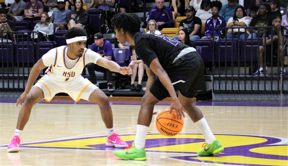 Hardin-Simmons guard Jason Justice (1) keeps Concordia's Jaylon Johnson at arm's length on defense in the second half of their American Southwest Conference tourney opener Tuesday.