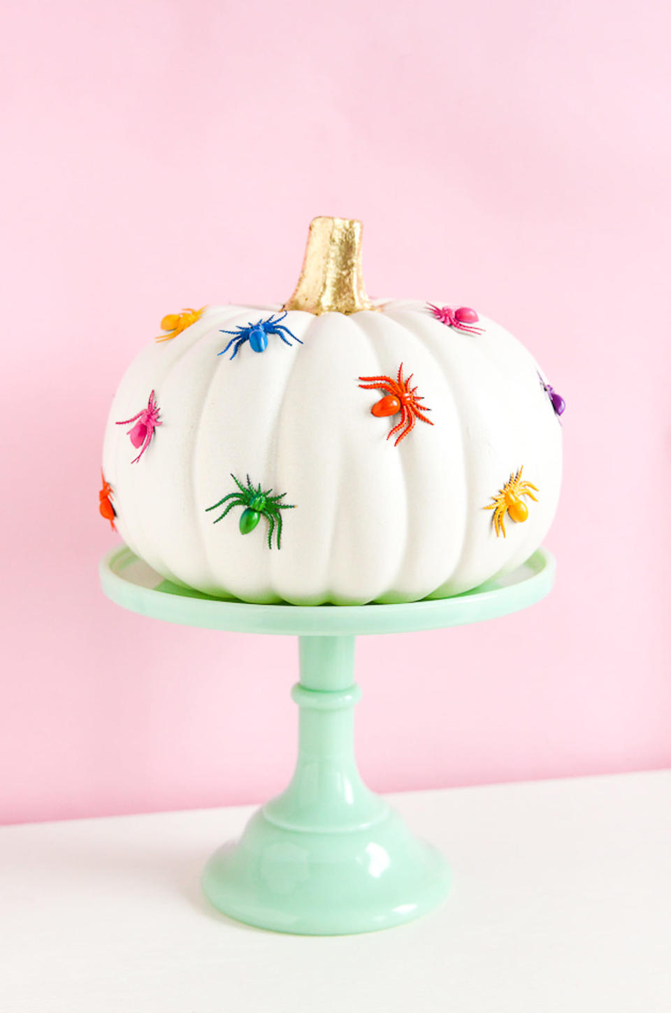 white pumpkin with colorful spiders (The Crafted Life )