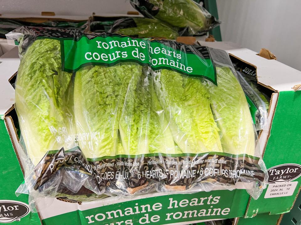 Clear plastic bag of romaine hearts with green label reading "romaine hearts"