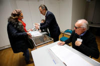 A woman casts her ballot in the second round of 2017 French presidential election at a polling station in Paris, France, May 7, 2017. REUTERS/Jean-Paul Pelissier