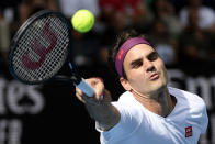 Switzerland's Roger Federer makes a forehand return to Tennys Sandgren of the U.S. during their quarterfinal match at the Australian Open tennis championship in Melbourne, Australia, Tuesday, Jan. 28, 2020. (AP Photo/Andy Brownbill)
