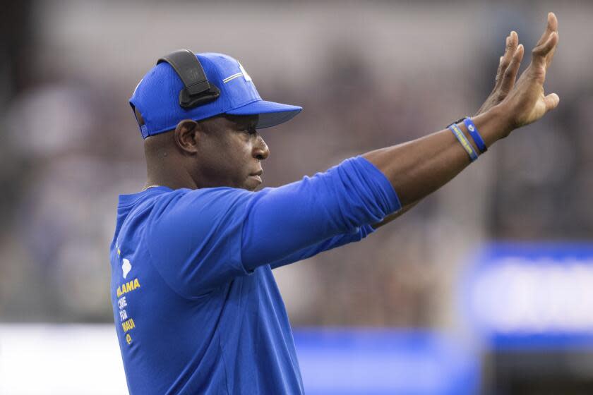 Rams defensive coordinator Raheem Morris extends his arms while standing on the sideline on Aug. 19