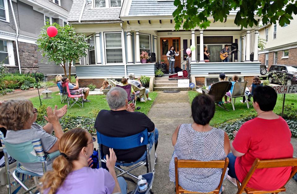 Visitors listen from lawn chairs as the band Roseblood performs during a 2016 porch music festival in west Erie. West Bayfront PorchFest 2023 will take place Sept. 30.