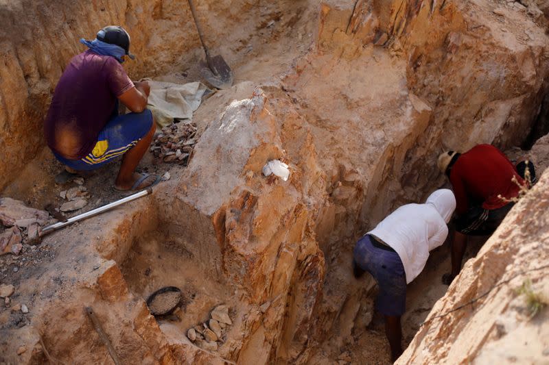 Indigenous people work in a gold mine at the Napoleao community in the Raposa Serra do Sol reservation