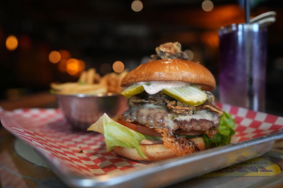 The Screech Owl smash burger with house-made crispy jalapeños, pepper jack cheese and pickle slabs at Night Owl Pizza and Drinks in Scottsdale on Feb. 23, 2023.