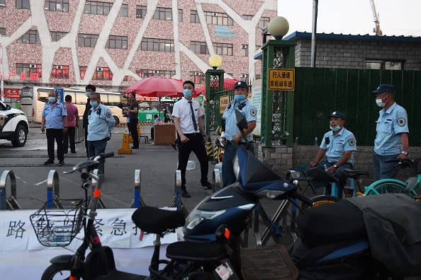 Chinese police block the entrance of the Xinfadi meat wholesale market in Beijing.