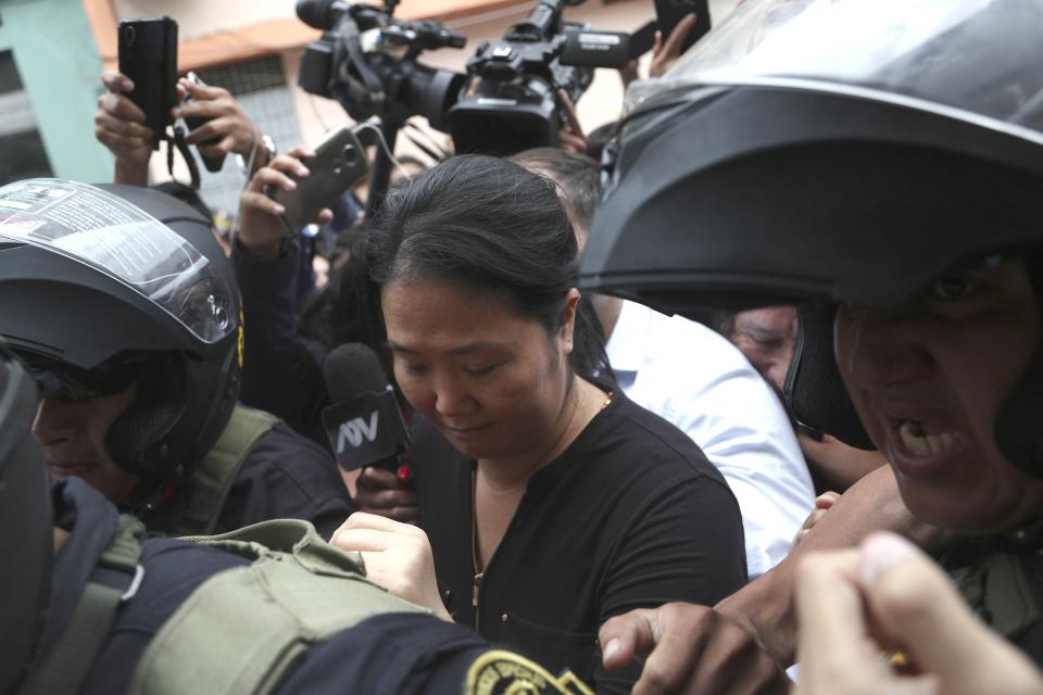 Keiko Fujimori, the daughter of Peru's former President Alberto Fujimori and opposition leader is escorted by police in Lima, Peru, Tuesday, Jan. 28, 2020. In a court session a judge decided she must return to preventive detention pending a corruption investigation. (AP Photo/Martin Mejia)