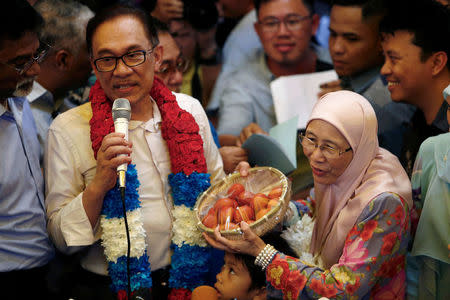 Malaysian politician Anwar Ibrahim speaks during a news conference next to his wife Wan Azizah Wan Ismail in Kuala Lumpur, Malaysia May 16, 2018. REUTERS/Lai Seng Sin