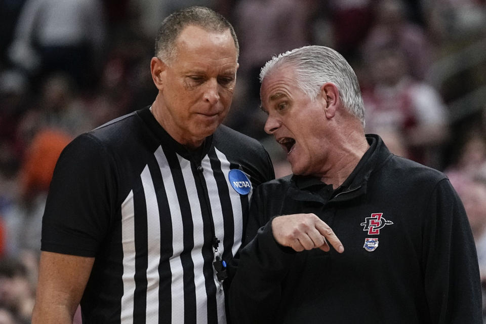 San Diego State head coach Brian Dutcher speaks with an official in the second half of a Sweet 16 round college basketball game in the South Regional of the NCAA Tournament against Alabama, Friday, March 24, 2023, in Louisville, Ky. (AP Photo/John Bazemore)