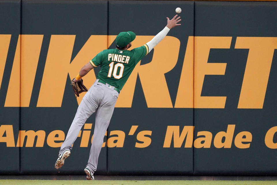 Oakland Athletics left fielder Chad Pinder (10) plays the ball off the wall on a double by Atlanta Braves' Ozzie Albies during the sixth inning of a baseball game Tuesday, June 7, 2022, in Atlanta. (AP Photo/John Bazemore)
