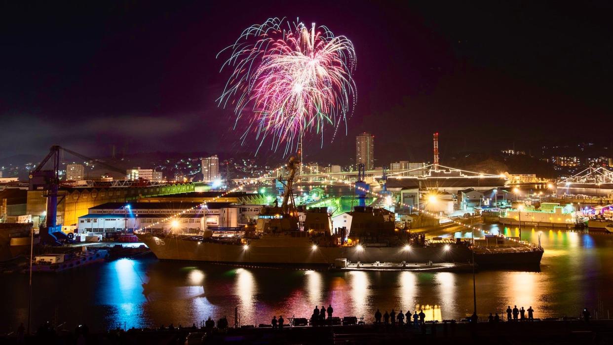 Sailors observe fireworks behind the Arleigh Burke class destroyer USS Benfold on New Year's Eve 2015, Yokosuka, Japan.