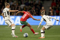 Morocco's Fatima Tagnaout vies for the ball with Germany's Alexandra Popp, left, and Svenja Huth during the Women's World Cup Group H soccer match between Germany and Morocco in Melbourne, Australia, Monday, July 24, 2023. (AP Photo/Hamish Blair)