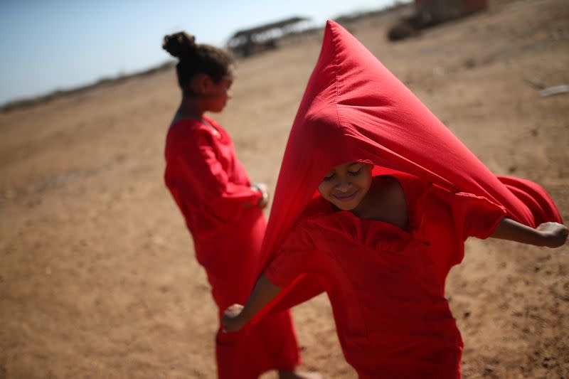 FILE PHOTO: A Colombian girl from the indigenous Wayuu tribe, plays with her tunic in the wind, before perfoming a dance called Yonna, in Castilletes