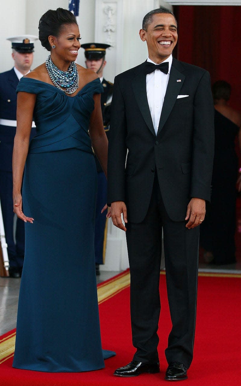 Michelle and Barack Obama in 2012. Michelle wears a blue dress.