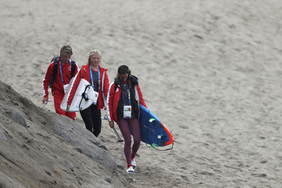 Canada surfers arrive to train one day before competing in the Pan American Games women's short board surfing competition on Punta Rocas beach in Lima, Peru, Sunday, July 28, 2019. Surfing is featured for the first time in the Pan Am Games. (AP Photo/Silvia Izquierdo)