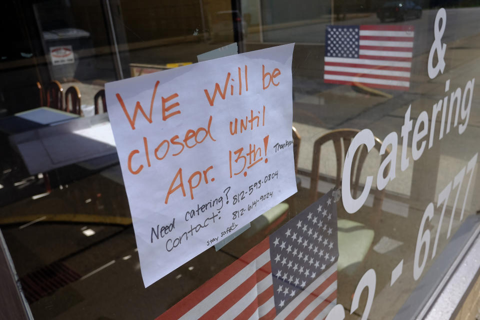 A closed sign is post on the window of Koch's Carry-Out & Catering, Thursday, April 2, 2020, in Greensburg, Ind. Three southeast Indiana counties have among the highest per-capita coronavirus infection rates in the country. (AP Photo/Darron Cummings)