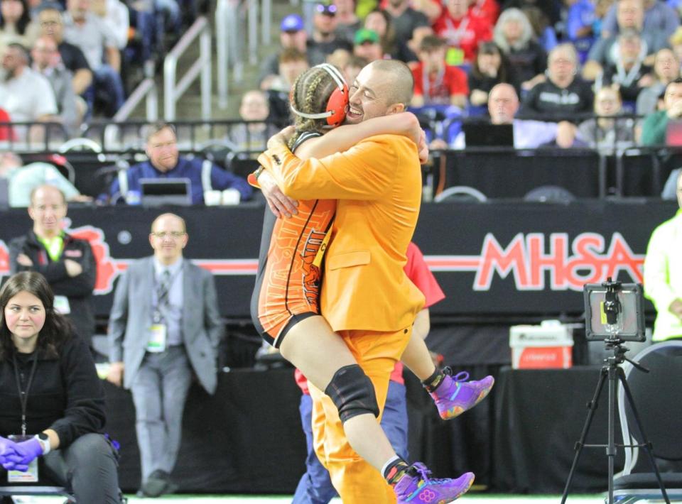 Sturgis coach, and dad, Brad Barkby catches a leaping Lola Barkby after she won the state championship on Saturday.
