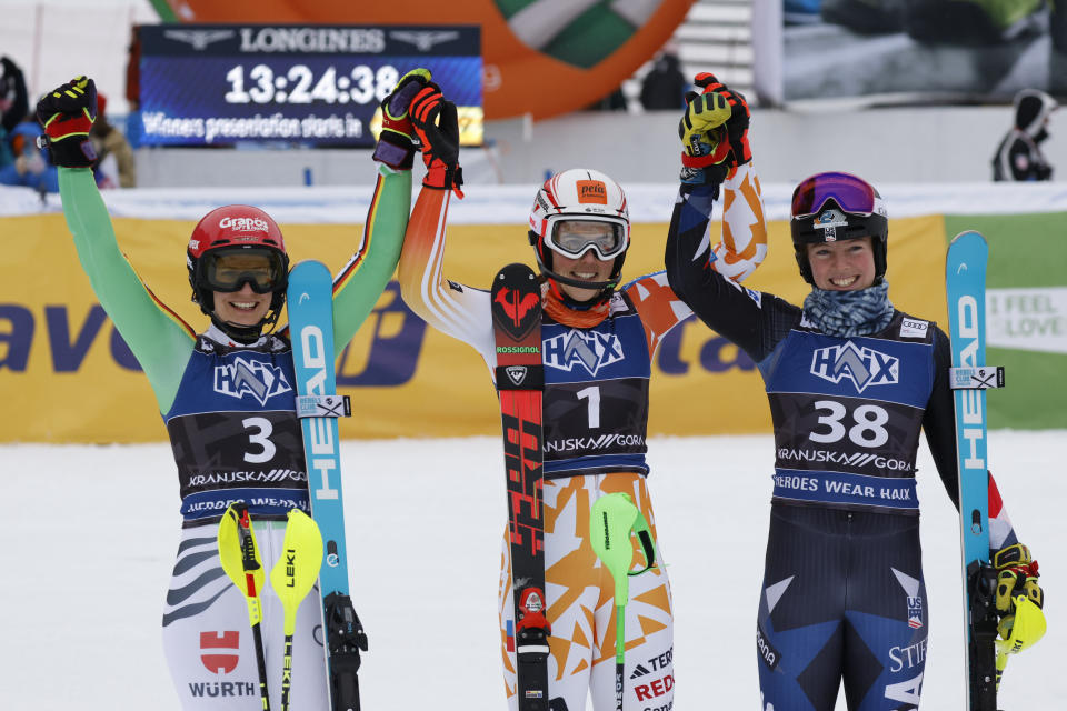 Slovakia's Petra Vlhova, center, winner of an alpine ski, women's World Cup slalom race, celebrates with second-placed Germany's Lena Duerr, left, and third-placed United States' A.J. Hurt, in Kranjska Gora, Slovenia, Sunday, Jan. 7, 2024. (AP Photo/Giovanni Maria Pizzato)