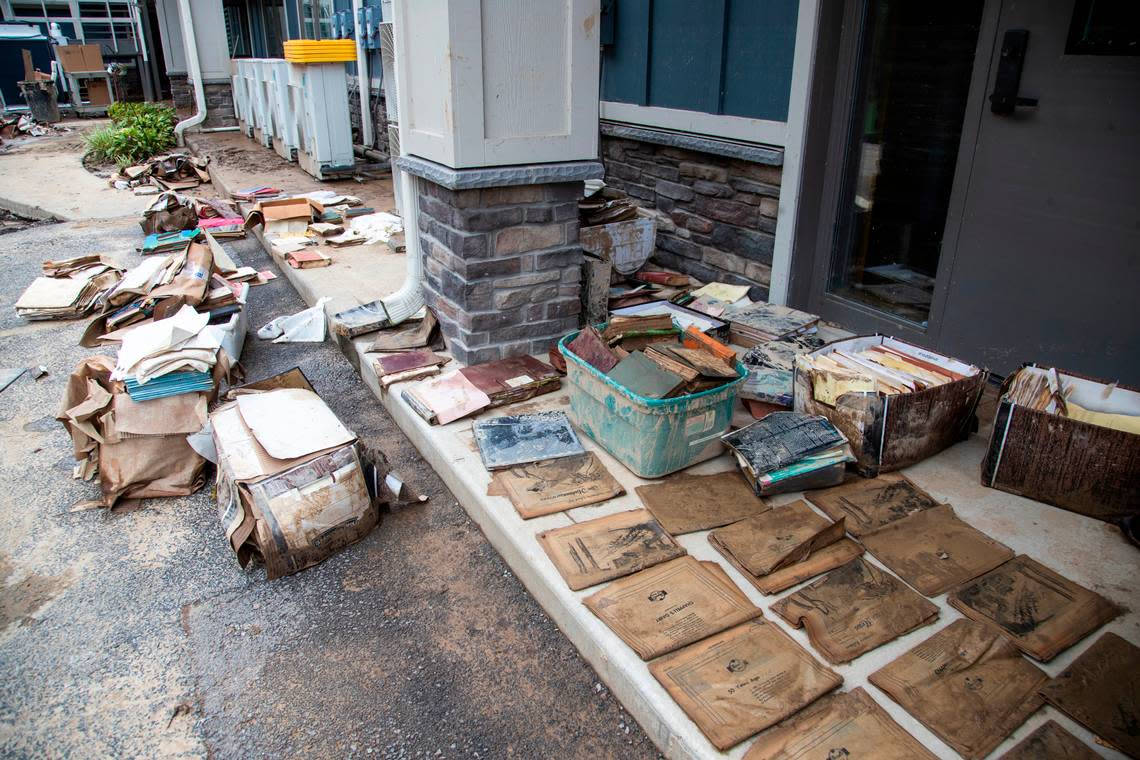 Salvaged historical documents and archives from the basement of the Hindman Settlement School lay on the sidewalk to dry after historic flooding damaged the entire first floor in the building in Hindman, Ky., Saturday, July 30, 2022.