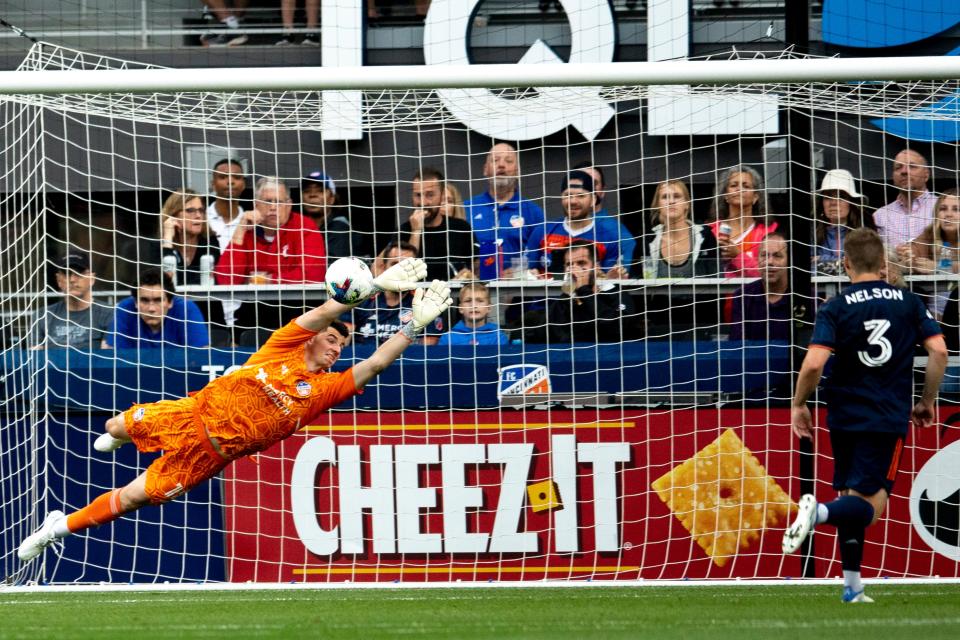 FC Cincinnati goalkeeper Roman Celentano (18) defends as a shot deflects off the pole in the first half of the MLS match between FC Cincinnati and New England Revolution at TQL Stadium in Cincinnati on Saturday, May 21, 2022. 