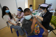 Health workers administer doses of the Pfizer-BioNTech COVID-19 vaccine at a hospital in Bangkok, Thailand, Tuesday, Sept. 21, 2021. Bangkok Metropolitan Administration inoculated 12-18 year old students Tuesday as part of its attempt to reopen on-site schools. (AP Photo/Sakchai Lalit)