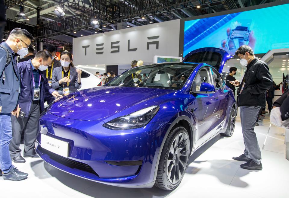 Visitors learn about a Tesla Model Y at the auto exhibition area of the China International Import Expo in Shanghai, China, Nov. 7, 2022. (CFOTO/Future Publishing via Getty Images)