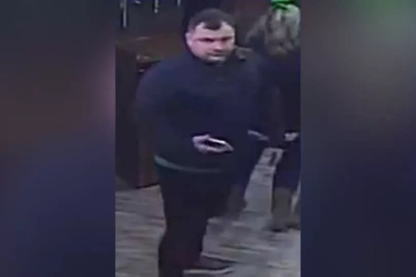 CCTV image of man standing inside building