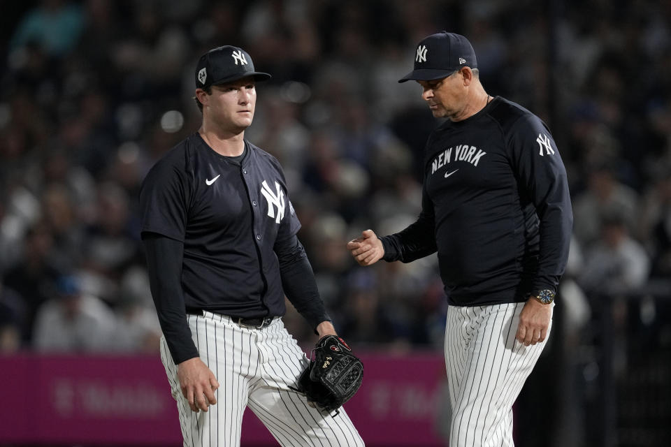 New York Yankees starting pitcher Gerrit Cole, left, reacts as he is taken out of the game by manager Aaron Boone during the first inning of a spring training baseball game against the Toronto Blue Jays Friday, March 1, 2024, in Tampa, Fla. (AP Photo/Charlie Neibergall)