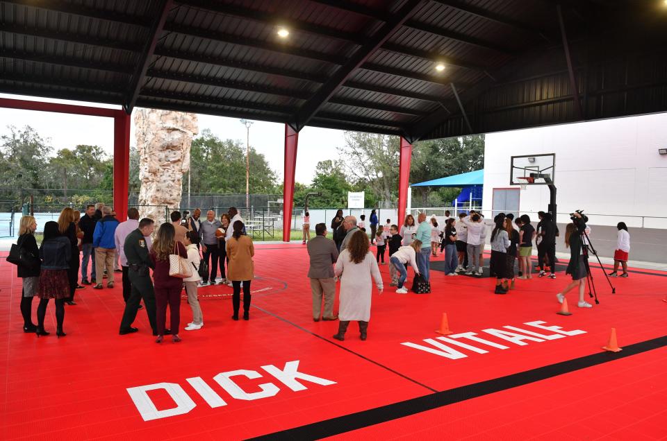 Guests walk around on the new Dream Court at the Sarasota Boys & Girls Club following a ceremony Thursday to dedicate the court in Dick Vitale's name.