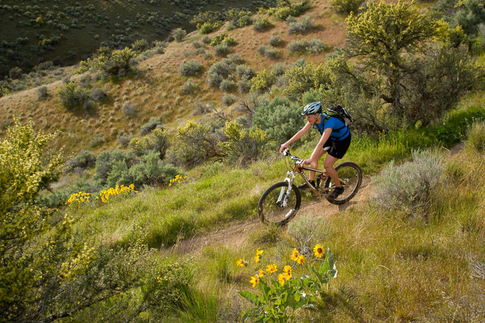 This 2010 photo provided by Boise Parks & Recreation shows a mountain biker on the Polecat Loop in the Ridge to Rivers trail system in Boise, Idaho. The foothills are also a playground for hikers, runners, mountain bikers and bird-watchers. The city manages a network of more than 130 miles (210 kilometers) of trails and numerous access points, some just minutes from downtown. Even a short, moderate hike along any of the trails provides enough elevation to overlook the city, the valley and the Owyhee Mountains across the valley floor. (AP Photo/Boise Parks & Recreation, Aaron Beck)