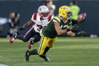 Green Bay Packers wide receiver Allen Lazard catches a pass ahead of New England Patriots cornerback Jonathan Jones, left, during the second half of an NFL football game, Sunday, Oct. 2, 2022, in Green Bay, Wis. (AP Photo/Matt Ludtke)