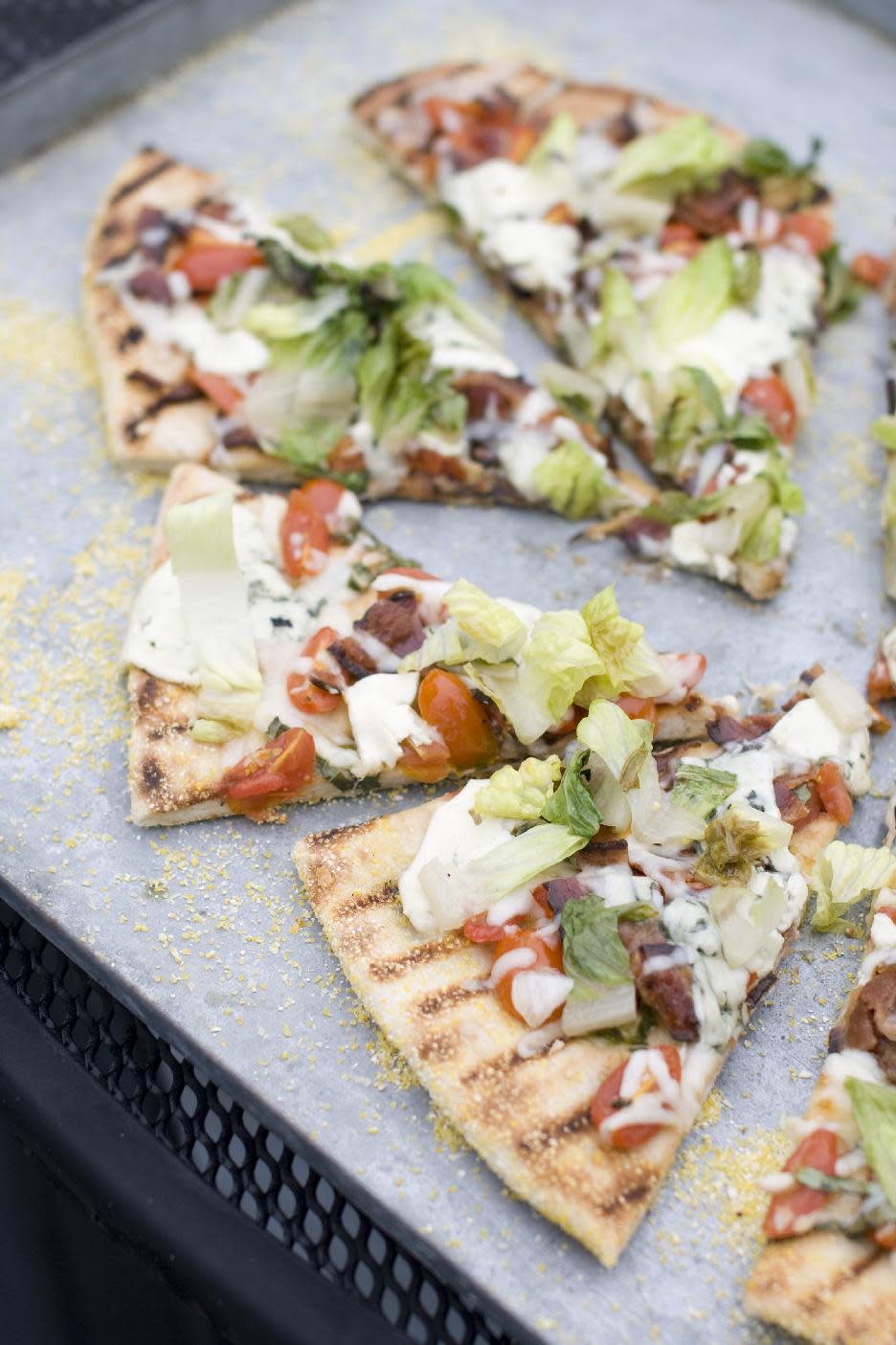 This July 22, 2013 photo taken in Concord, N.H., shows a recipe for grilled BLT pizza with summer tomato-basil sauce. (AP Photo/Matthew Mead)