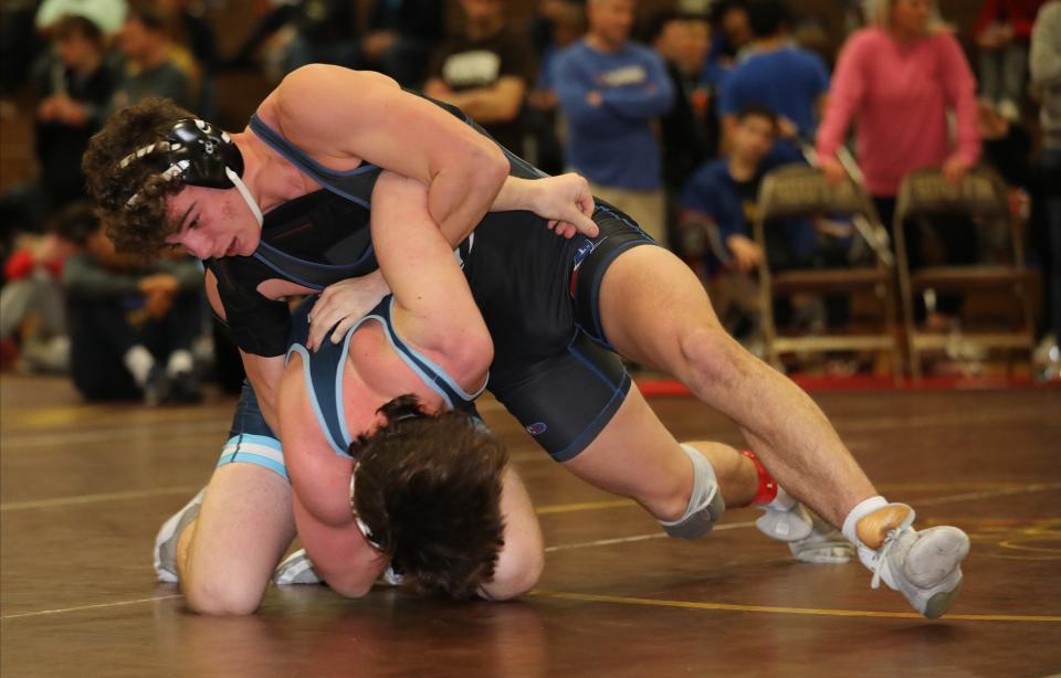 Leo Venables from Carmel on his way to defeating Danny Morrison from John Jay EF in the 170 pound match during the wrestling divisional at Clarkstown South High School in West Nyack, Feb. 3, 2024.