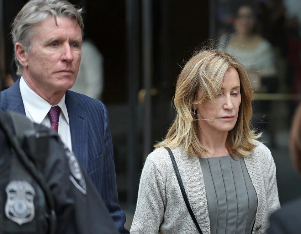 BOSTON, MA - MAY 13: Actress Felicity Huffman, right, leaves the John Joseph Moakley United States Courthouse with her brother Moore Huffman Jr., left, in Boston on May 13, 2019. Huffman was among 50 people charged in March as part of Operation Varsity Blues, which found that wealthy parents had allegedly paid bribes to get their children falsely certified as athletic recruits at elite colleges and universities, or to facilitate cheating on their kids SAT and ACT scores. Assistant US Attorney Eric Rosen said, as part of a plea agreement, he will be seeking four months in prison and a $20,000 fine for Huffman. (Photo by David L. Ryan/The Boston Globe via Getty Images)