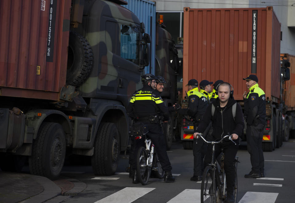 Police and army trucks block the roads leading to parliament during a farmers demonstration in The Hague, Netherlands, Wednesday, Feb. 19, 2020. Dutch farmers, some driving tractors, poured into The Hague on Wednesday to protest government moves to rein in carbon and nitrogen emissions to better fight climate change. (AP Photo/Peter Dejong)