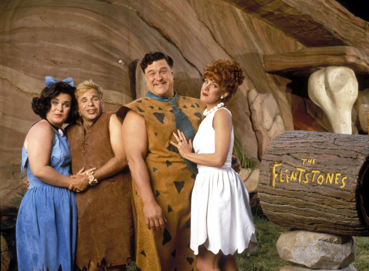 Rosie O'Donnell, Rick Moranis, John Goodman, and Elizabeth Perkins in 1994's The Flintstones. (Alamy)