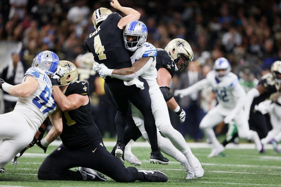 Lions linebacker Bruce Irvin tackles Saints quarterback Derek Carr, causing an injury, during the second half of the Lions' 33-28 win on Sunday, Dec. 3, 2023, in New Orleans.