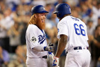 <p>Justin Turner #10 of the Los Angeles Dodgers celebrates with Yasiel Puig #66 after hitting a two-run home run during the sixth inning against the Houston Astros in game one of the 2017 World Series at Dodger Stadium on October 24, 2017 in Los Angeles, California. (Photo by Sean M. Haffey/Getty Images) </p>