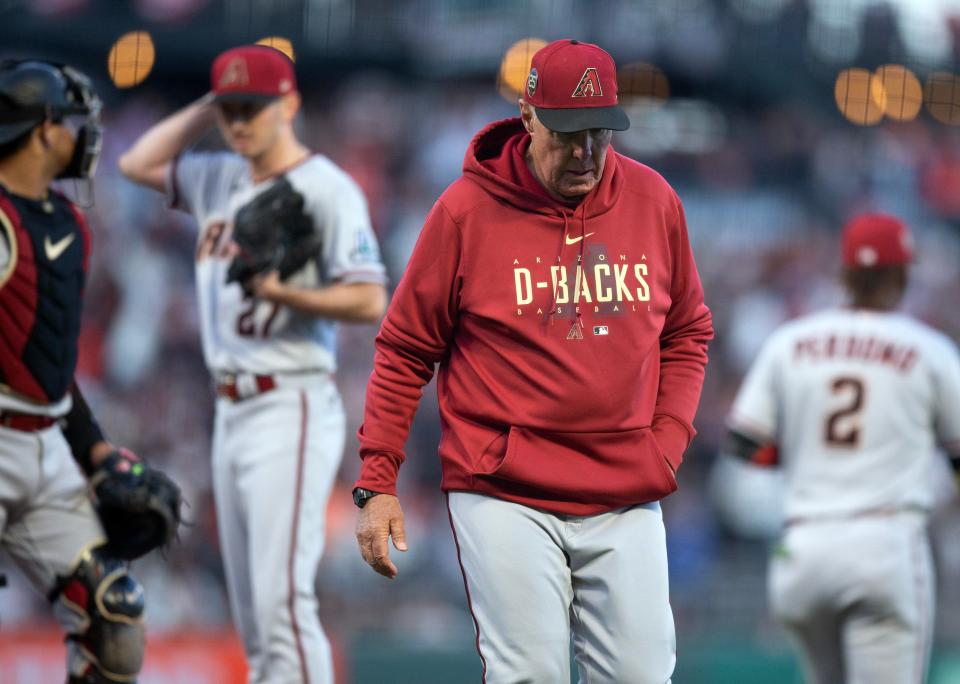 Arizona Diamondbacks pitching coach Brent Strom (right) walks back to the dugout after conferring with starting pitcher Zach Davies during the third inning against the San Francisco Giants at Oracle Park in San Francisco on June 23, 2023.
