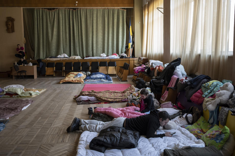 Internally displaced rest inside a school in Lviv, western Ukraine, Monday, March 14, 2022. Overnight, air raid alerts sounded in cities and towns around the country, from near the Russian border in the east to the Carpathian Mountains in the west, and fighting continued on the outskirts of Kyiv. Ukrainian officials said Russian forces shelled several suburbs of the capital. (AP Photo/Bernat Armangue)