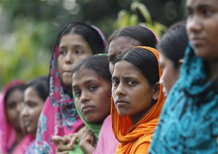 Garment workers gather in front of the head office of Bangladesh Garment Manufactures & Exporters Association (BGMEA), during a protest in Dhaka September 23, 2013. REUTERS/Andrew Biraj