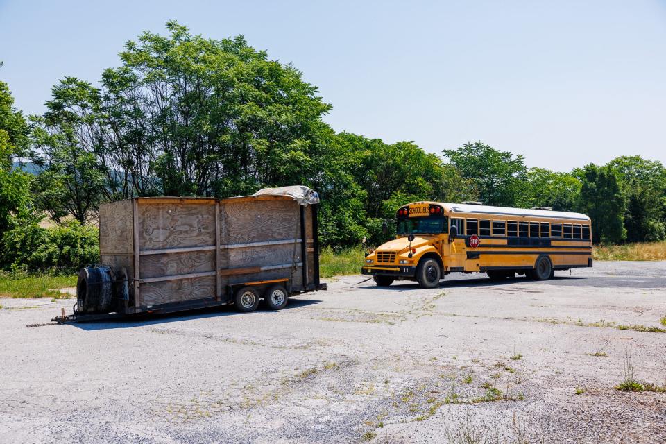 A bus and a trailer are seen on the side of the road along Hanover Road after Adams County SPCA officials removed more than 30 animals from horrific conditions inside, Monday, June 17, 2024, in Oxford Township.