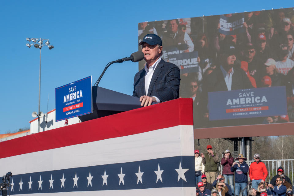 Former U.S. Senator and Republican candidate for Governor of Georgia David Perdue waves to supporters of former U.S. President Donald Trump after speaking at a rally at the Banks County Dragway on March 26, 2022 in Commerce, Georgia. This event is a part of Trump's Save America Tour around the United States. / Credit: Megan Varner / Getty Images