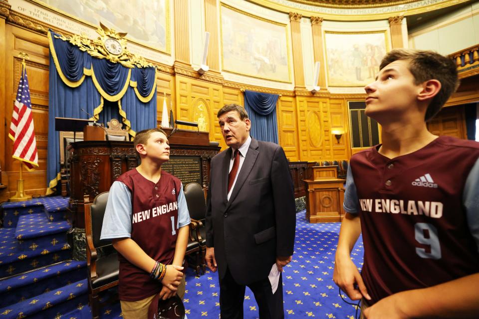 Middleboro Little League Williamsport All-Stars visit with state Sen. Marc Pacheco, D. Taunton, inside the House of Representatives chamber at the State House on Tuesday, Nov. 1, 2022. From left, Cayden Ellis, Pacheco and Aaron Davis.