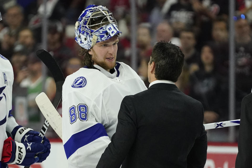 Tampa Bay Lightning goaltender Andrei Vasilevskiy (88) speaks with Carolina Hurricanes coach Rod Brind'Amour following Game 5 of an NHL hockey Stanley Cup second-round playoff series in Raleigh, N.C., Tuesday, June 8, 2021. (AP Photo/Gerry Broome)