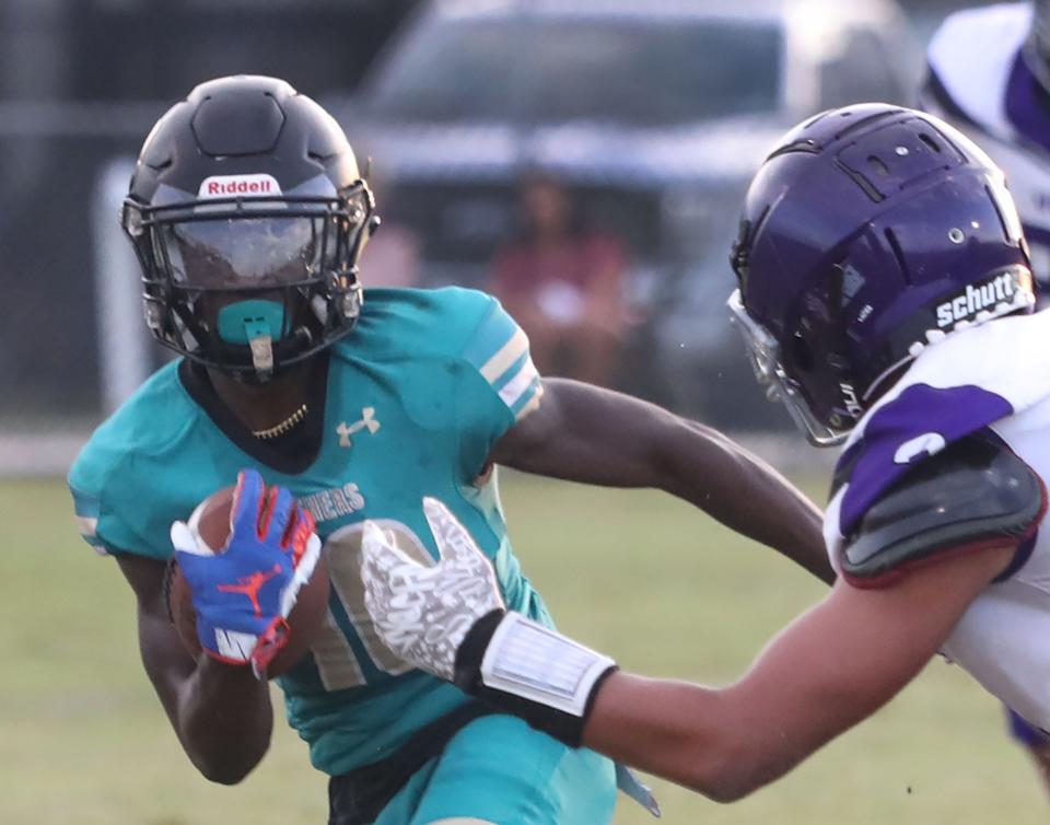 Pine Ridge High's Chris Boddie #10 turns the corner as a Space Coast player gives chase, Friday September 8, 2023.