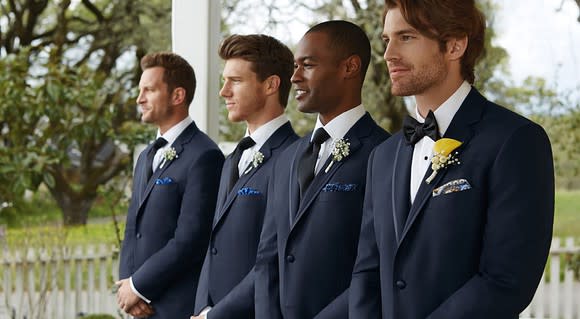 Four men wearing tuxedos.