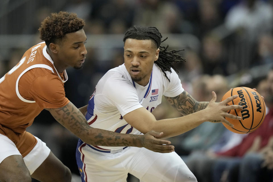 Texas guard Arterio Morris, left, pressures Kansas guard Bobby Pettiford Jr. during the first half of the NCAA college basketball championship game of the Big 12 Conference tournament Saturday, March 11, 2023, in Kansas City, Mo. (AP Photo/Charlie Riedel)