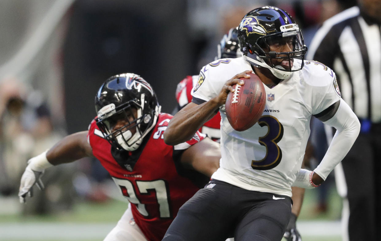 Baltimore Ravens quarterback Robert Griffin III (3) runs out of the pocket as Atlanta Falcons defensive tackle Grady Jarrett (97) defends during the second half of an NFL football game, Sunday, Dec. 2, 2018, in Atlanta. (AP Photo/John Bazemore)